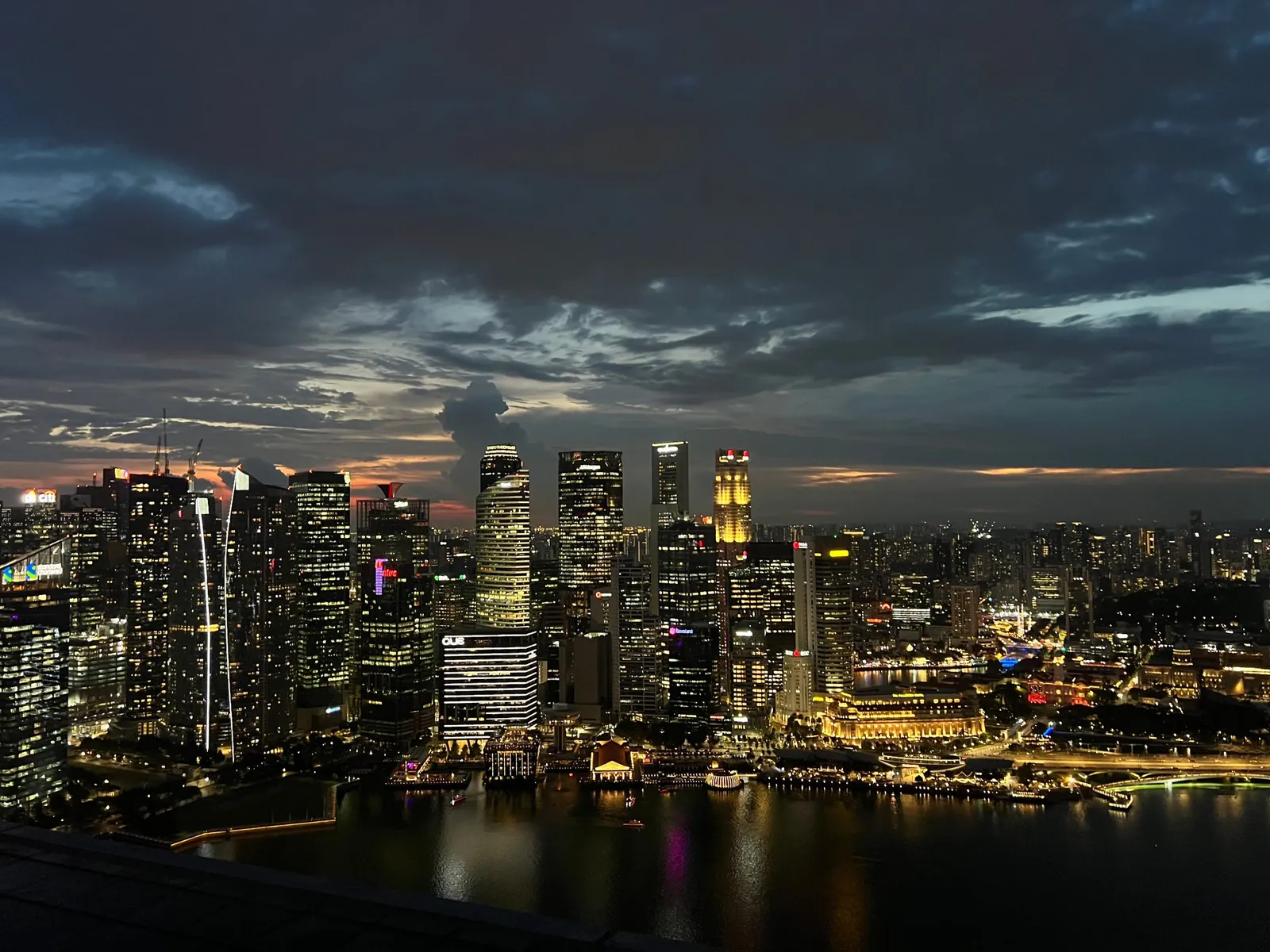 A city skyline lit up at dusk
